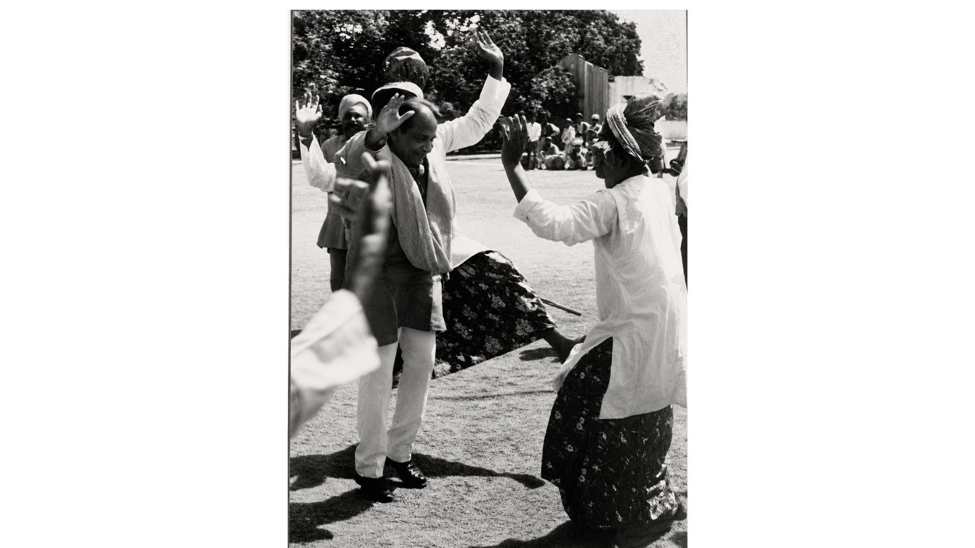 Archival photograph — Sharing a joyful dance at a festive occasion